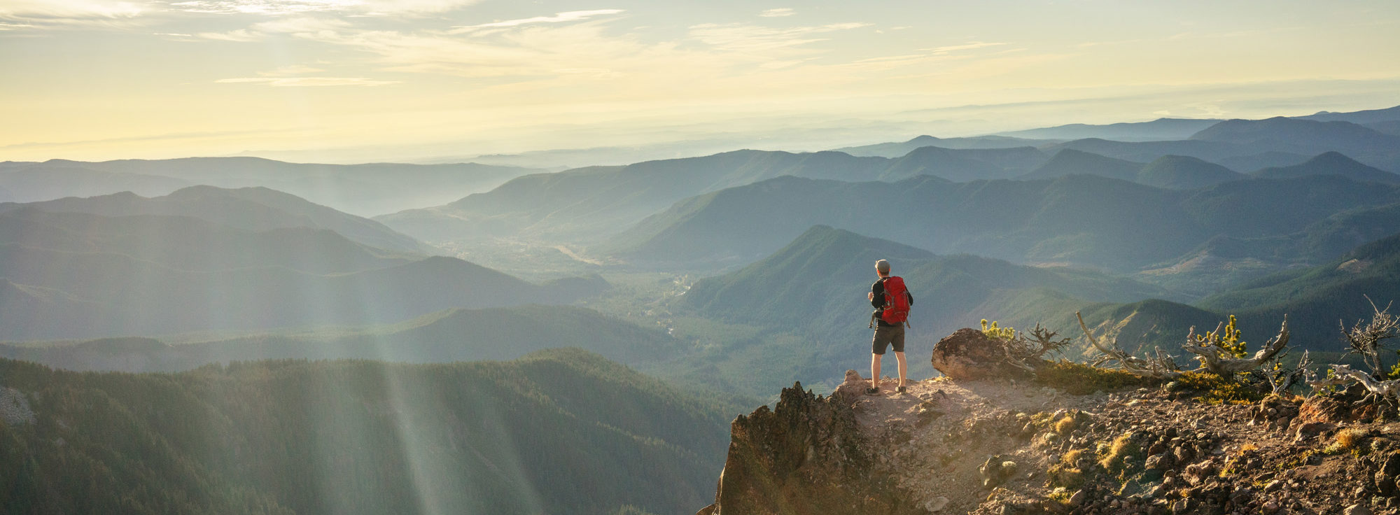 Man looking out at a mountain range