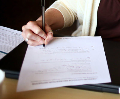 Image of a hand taking notes