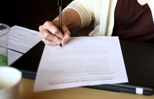 Image of a hand taking notes