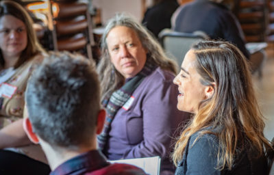 A group of people talking at a conference