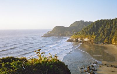 The view from the Pacific Coast Scenic Byway north of Florence. Heceta Head Lighthouse is in the distance. Photographer: