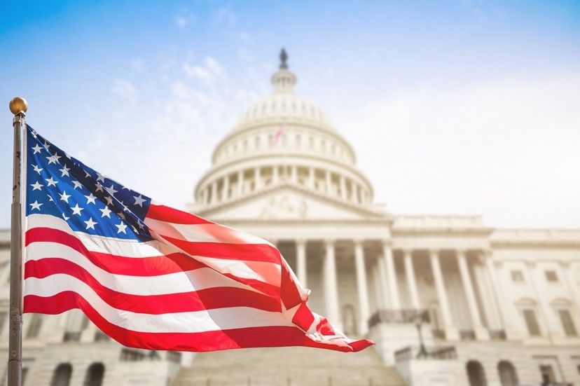 American flag flying in front of Capitol buliding