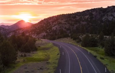 Road in Eastern Oregon with sunset in the distance.