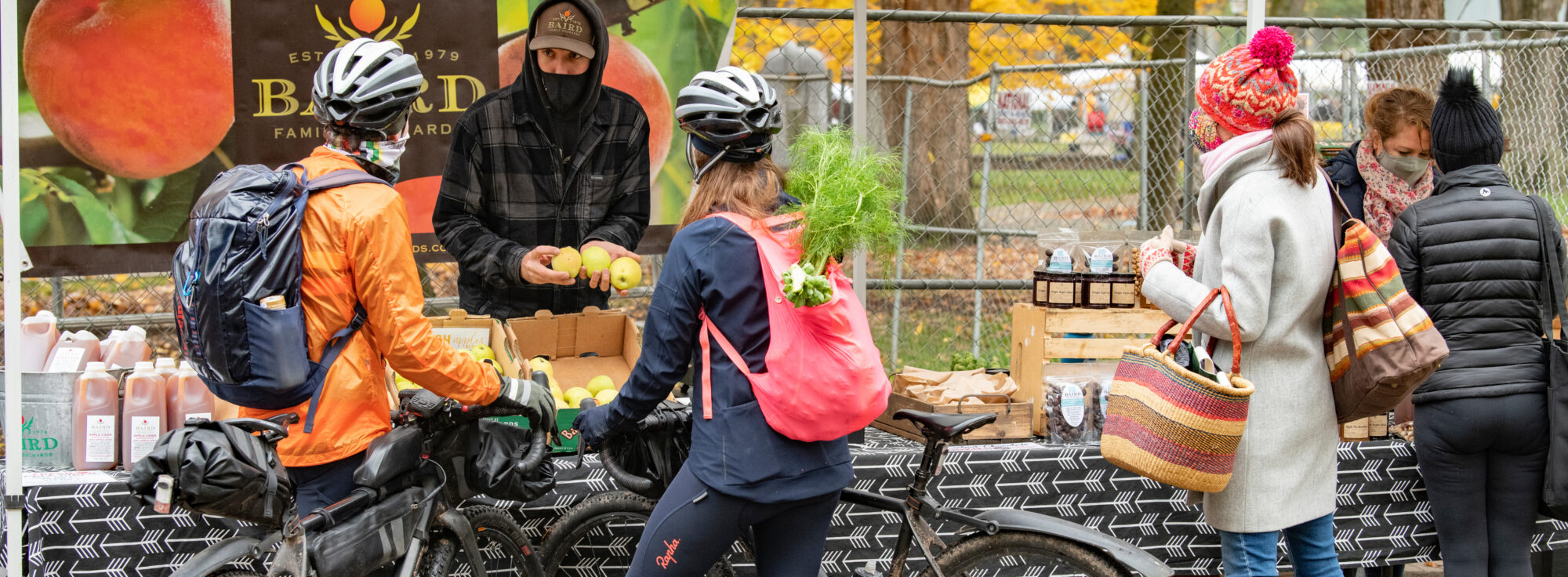 Image of cyclists shopping for produce at the Portland Farmers Market.