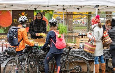 Image of cyclists shopping for produce at the Portland Farmers Market.