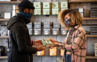 Two masked customers shopping for tea at Smith Tea in Portland.