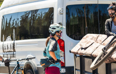 Cyclists unloading bikes from Cogwild tour van.