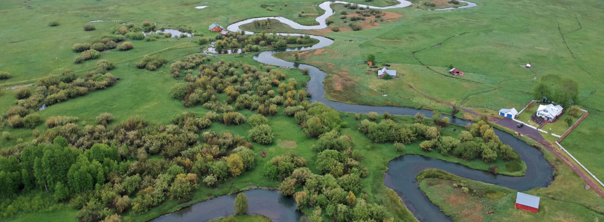 Winding creek through farmland in Klamath Falls.