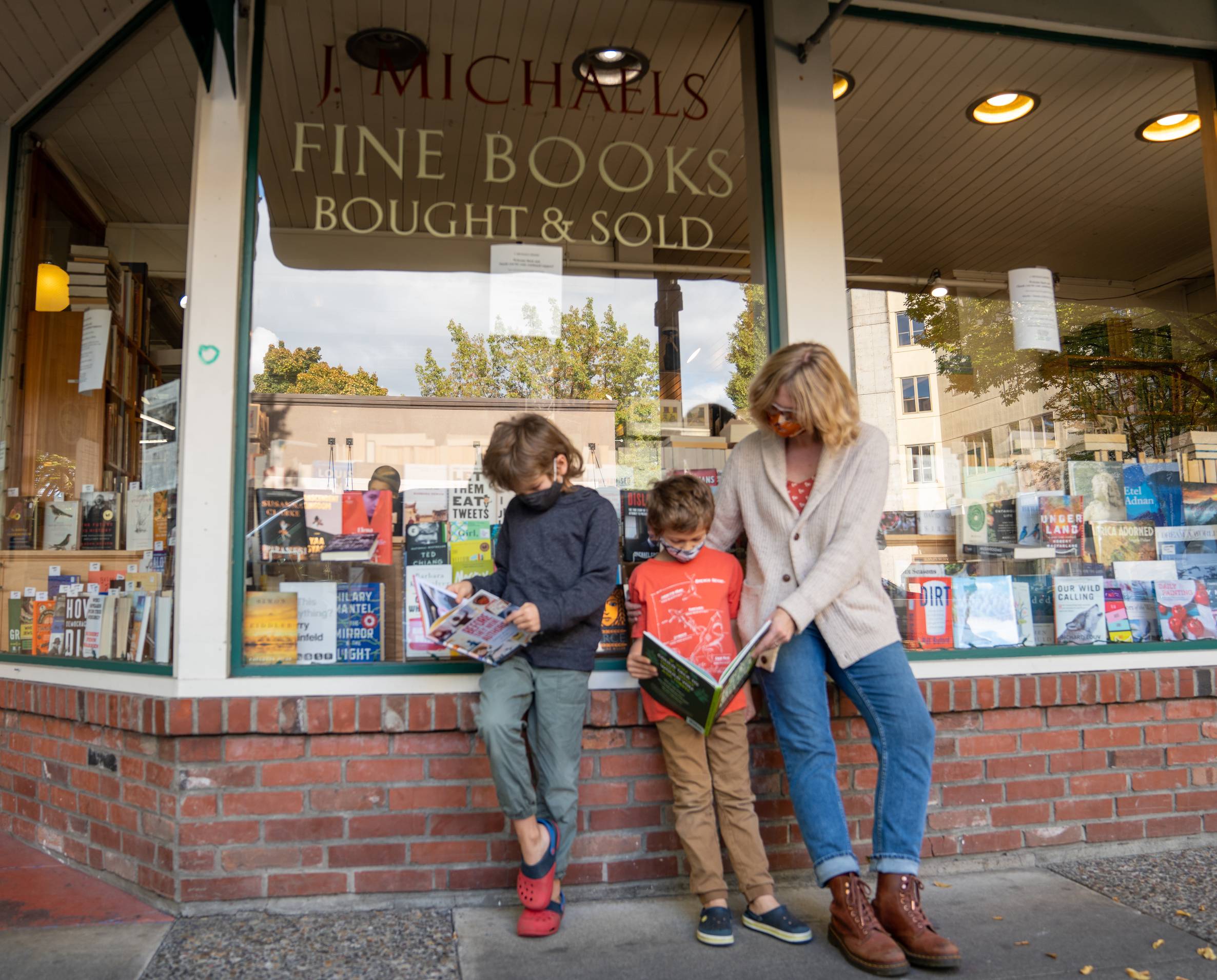 Family standing in front of a book store.