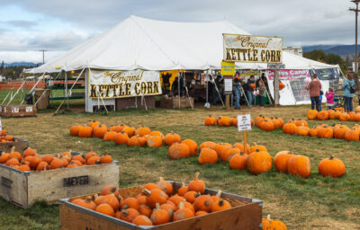 large tent outdoors selling pumpkins and kettle corn