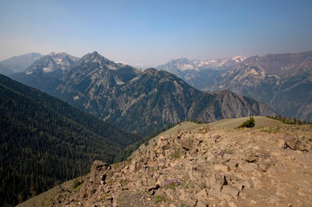 View of layered rocky hills and cliffs with a hazy blue sky